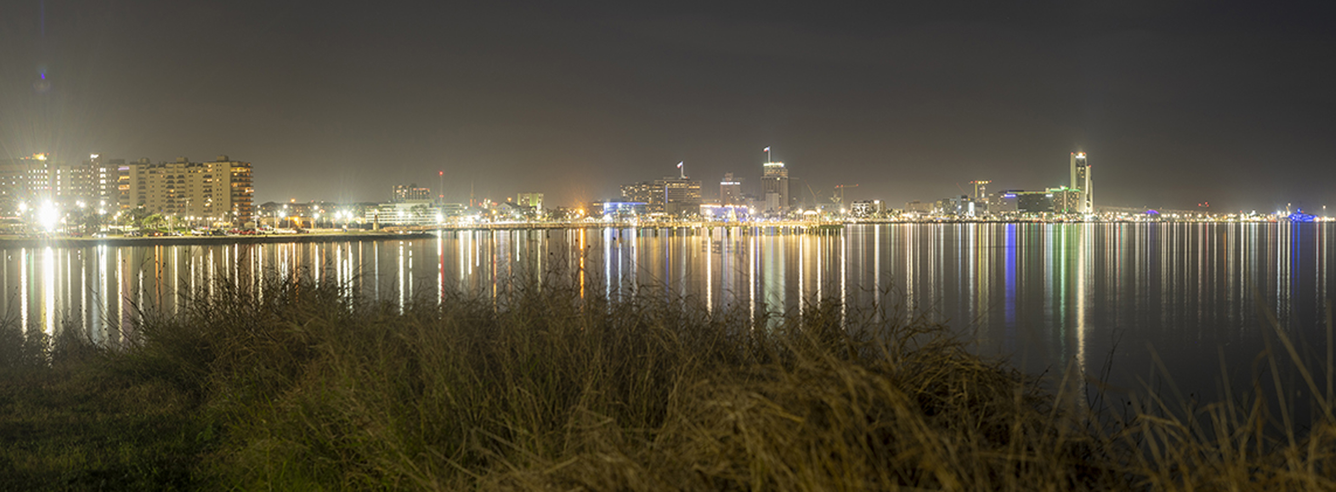 Night view of the downtown Corpus Christi skyline reflected across Corpus Christi Bay as seen from Ocean Drive.